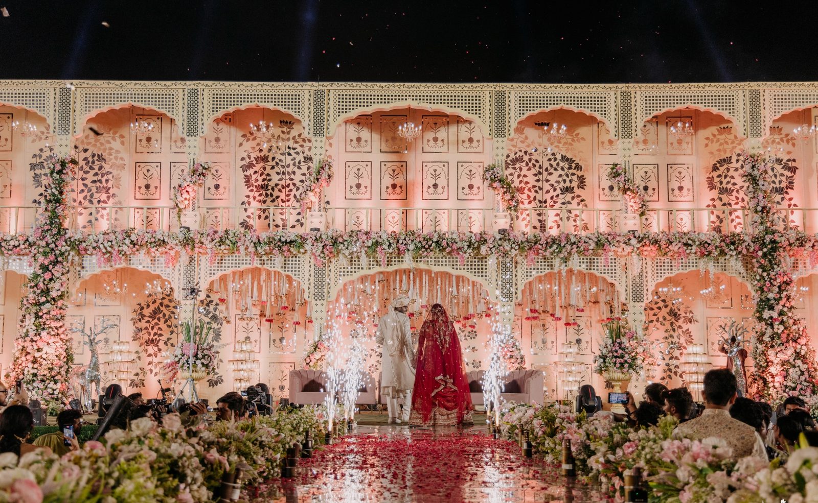 An Ekaa wedding stage glowing under evening light, couple at the centre